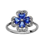 Bague argent rhodi� tr�fle pierres bleues entourage oxydes blancs sertis