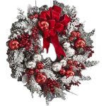 Couronne de no�l artificielle en rotin recouvert de neige, arbre renvers�, n?ud rouge, ruban, mise en ...