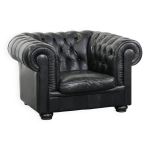 Fauteuil chesterfield noir confortable en cuir de vache.