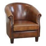 Fauteuil club en cuir de mouton discret et soign avec coussin d'assise fixe de couleur cognac fonc ...