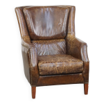 Fauteuil en cuir de vachette grain� au design intemporel