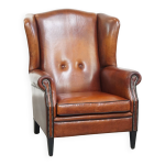 Fauteuil  oreilles en peau de mouton aux tons chauds et passepoil noir