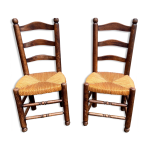 Paire de chaises brutaliste vintage en bois et paille Paire de chaises brutaliste vintage en bois et paille