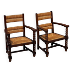 Paire de fauteuils chne teint et paille, travail franais 1950