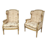 Paire de fauteuils dorés à oreilles louis 16 Paire de fauteuils dorés à oreilles louis 16