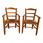 Paire de fauteuils vintage en bois massif et paille georges robert Paire de fauteuils vintage en bois massif et paille georges robert