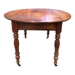 Table  volets ovale louis philippe en cerisier massif avec 2 tiroirs.