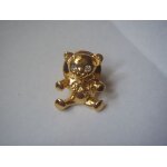 Pin's yves rocher: ourson dor� avec yeux en pierre.