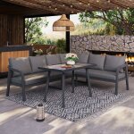 Un ensemble de mobilier de jardin en rotin gris compos� de trois pi�ces comprenant une table basse et ...