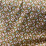 Maille jersey coton ocre motifs ptales roses verts - domotex - mondial tissus