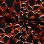 Maille jersey viscose motifs tches 3d noir fond orange - mondial tissus