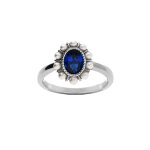 Bague en argent rhodi� avec oxyde central bleu contour perle blanches imitation