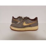 Basket femme nike air force 1 low - edition speciale - gris / swoosh dore / semelle gum